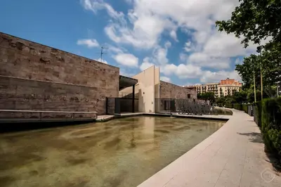 a pool of water in front of a building at CITY CENTER TWO BEDROOMS APARTMENT, IN A 1870's FULL RENEWED BUILDING in Barcelona