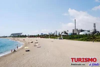 a group of people on a beach near the water at Waterfront Cozy two bedrooms in Barcelona
