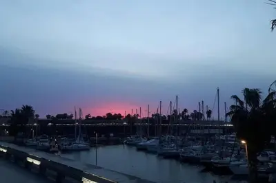 a group of boats docked in a marina at dusk at Waterfront Cozy two bedrooms in Barcelona