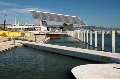 a dock with a building on top of the water at Waterfront Cozy two bedrooms in Barcelona