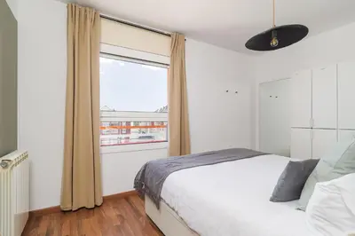 a bedroom with a bed and a large window at Bright Apt With Amazing Views in Barcelona
