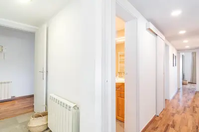 a hallway with white walls and a radiator at Bright Apt With Amazing Views in Barcelona