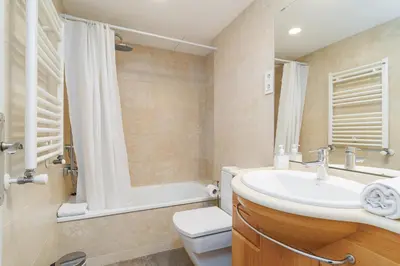 a bathroom with a sink and a toilet and a shower at Bright Apt With Amazing Views in Barcelona