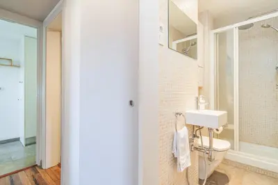 a bathroom with a white toilet and a sink at Bright Apt With Amazing Views in Barcelona
