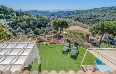 an aerial view of a yard with chairs and a pool at Stunning Home In Arenys De Munt in Arenys de Munt