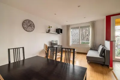 a kitchen and living room with a table and chairs at Stay U-nique Apartments Lepant II in Barcelona