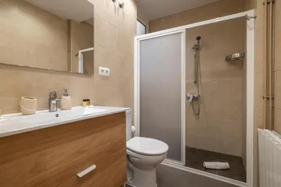 a bathroom with a shower and a toilet and a sink at Stay U-nique Apartments Lepant II in Barcelona