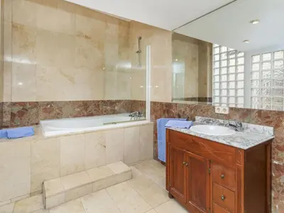 a bathroom with a tub and a sink and a bath tub at Apartment Icaria by Interhome in Barcelona