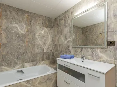 a bathroom with a sink and a mirror at Holiday Home Bon repos by Interhome in Cunit