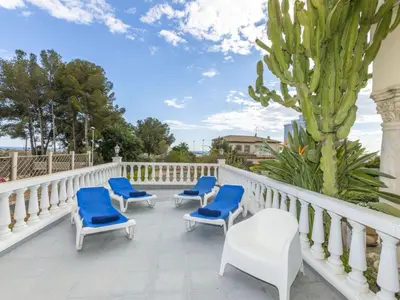 a row of blue chairs sitting on a balcony at Holiday Home Bon repos by Interhome in Cunit