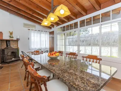 a dining room with a large glass table and chairs at Holiday Home Bon repos by Interhome in Cunit