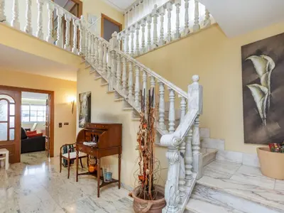 a white staircase in a living room with a piano at Holiday Home Bon repos by Interhome in Cunit