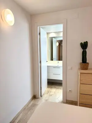 a bedroom with a bed and a bathroom with a mirror at Boutique Temporada VG Barcelona Sant Gervasi in Barcelona