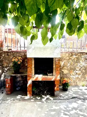 a brick fireplace with two potted plants on it at Mi casa soñada in Sant Pere de Ribes