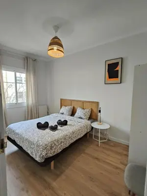 a bedroom with a bed with shoes on it at Charming apartment Poblenou beach in Barcelona