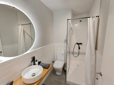 a bathroom with a toilet and a sink and a mirror at Charming apartment Poblenou beach in Barcelona