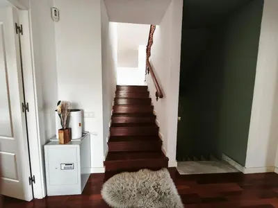 a hallway with a staircase with a green wall at Luxury Villa in Vallromanes - Mountain Views, Pool, Close to Barcelona and the Beach in Vallromanas
