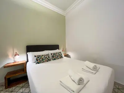 a bedroom with a white bed with towels on it at Stay U-nique Apartments Comte Urgell in Barcelona