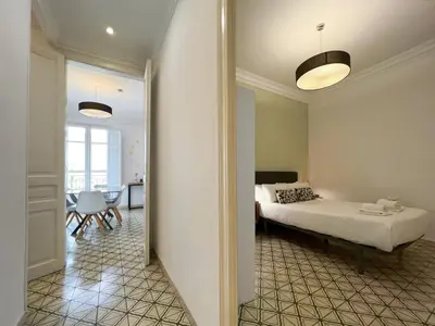 a bedroom with a bed and a dining room at Stay U-nique Apartments Comte Urgell in Barcelona