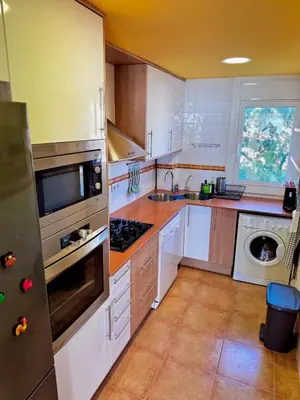a kitchen with white cabinets and a stove top oven at Apartamento Canet de Mar - Primera linea de Playa - Increibles vistas al Mar in Canet de Mar