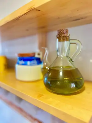 a glass jug of oil sitting on a shelf at Apartamento Canet de Mar - Primera linea de Playa - Increibles vistas al Mar in Canet de Mar