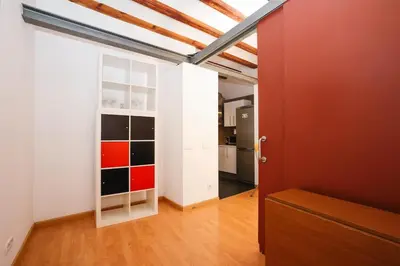 an empty room with a white door and a red wall at La Rambla - Catalonia Square Apt 4BD-2BTH in Barcelona