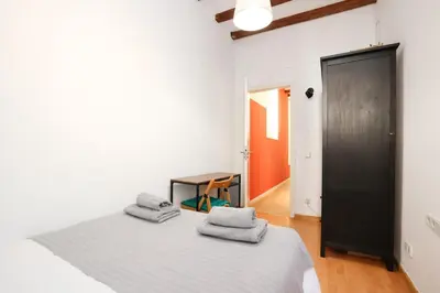 a bedroom with a bed with towels on it at La Rambla - Catalonia Square Apt 4BD-2BTH in Barcelona