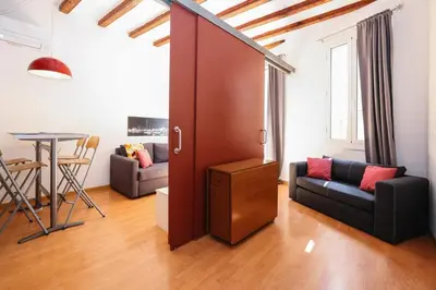 a living room with a couch and a table at La Rambla - Catalonia Square Apt 4BD-2BTH in Barcelona