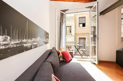 a living room with a couch and a large window at La Rambla - Catalonia Square Apt 4BD-2BTH in Barcelona