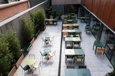 an overhead view of a patio with tables and chairs at Barcelona Pere Tarrés Youth Hostel in Barcelona