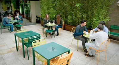 a group of people sitting at tables in a restaurant at Barcelona Pere Tarrés Youth Hostel in Barcelona