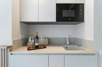 a kitchen counter with a sink and a microwave at L'Hostalet de Cabrils in Cabrils