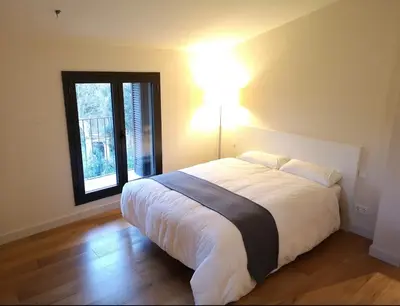 a bedroom with a large bed and a window at Beautiful 15th century villa on 30 acre estate, for families only in Alella