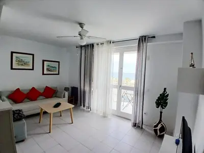a living room with a couch and a large window at MM4-Apto en 1ª linea de playa in Mataró