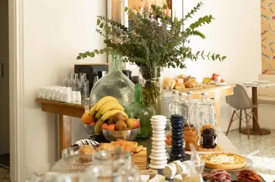 a table with a bunch of food and wine bottles at Forget Me Not Barcelona in Barcelona