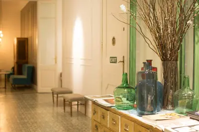 a room with a table with bottles on it at Forget Me Not Barcelona in Barcelona