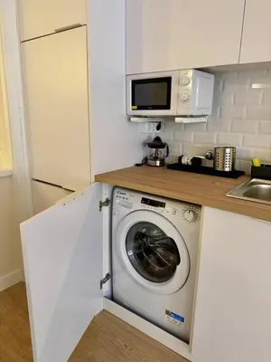 a kitchen with a washing machine and a microwave at Loft Premium en Barcelona in Barcelona