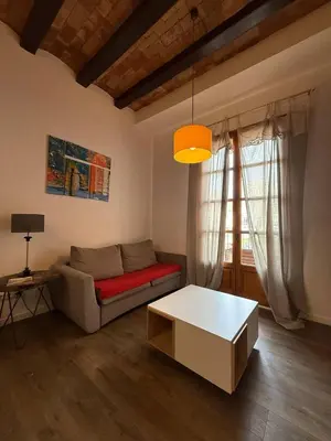 a living room with a couch and a table at Centric 2 Bedroom Apartment in Barcelona