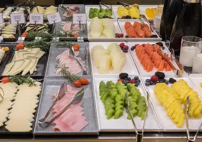 a buffet with many different types of food on plates at Hotel Àmbit Barcelona in Barcelona