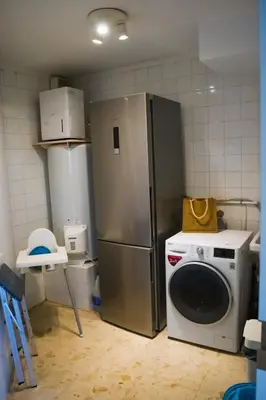 a kitchen with a refrigerator and a washing machine at Exclusive Mediterranean Panorama in Sant Pol de Mar in San Pol de Mar
