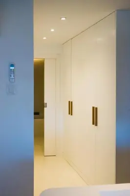 a room with white cabinets and a hallway at Exclusive Mediterranean Panorama in Sant Pol de Mar in San Pol de Mar