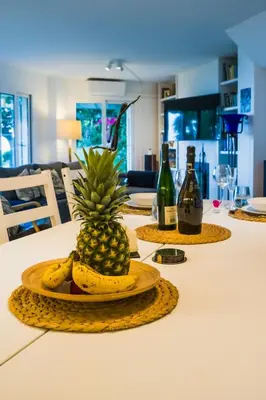 a table with a pineapple and bananas on a plate at Exclusive Mediterranean Panorama in Sant Pol de Mar in San Pol de Mar
