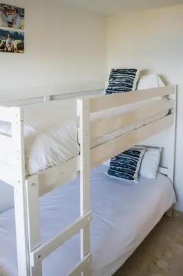 two bunk beds in a room with a white wall at Exclusive Mediterranean Panorama in Sant Pol de Mar in San Pol de Mar