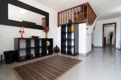 a living room with a staircase and a rug at Bellavista in Argentona