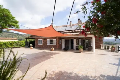 a house with an orange roof on a patio at Bellavista in Argentona