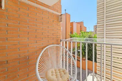 a white chair sitting next to a brick wall at Mediterranean Soul Experience in Montgat