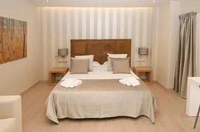 a bedroom with a large bed with towels on it at Serennia Exclusive Rooms in Barcelona