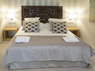 a bedroom with a large bed with towels on it at Serennia Exclusive Rooms in Barcelona