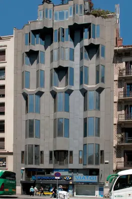 a tall building with windows on the side of it at Serennia Exclusive Rooms in Barcelona