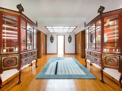 a large room with wooden cabinets and a blue rug at Cal Tomas in Castellet